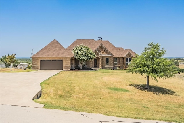 craftsman house featuring a garage and a front yard