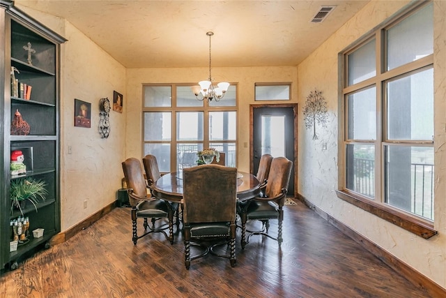 dining area with a chandelier and dark hardwood / wood-style floors