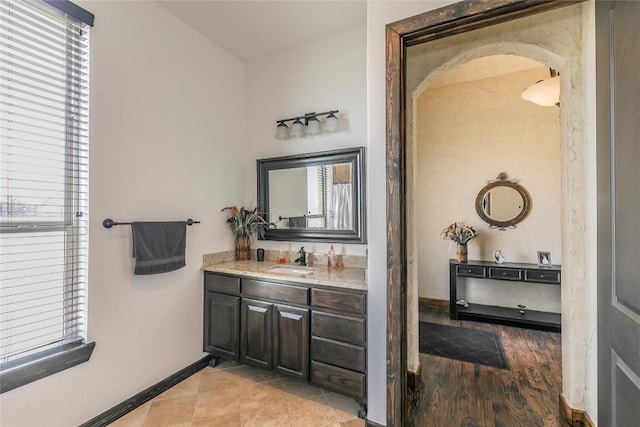 bathroom with a wealth of natural light, wood-type flooring, and vanity