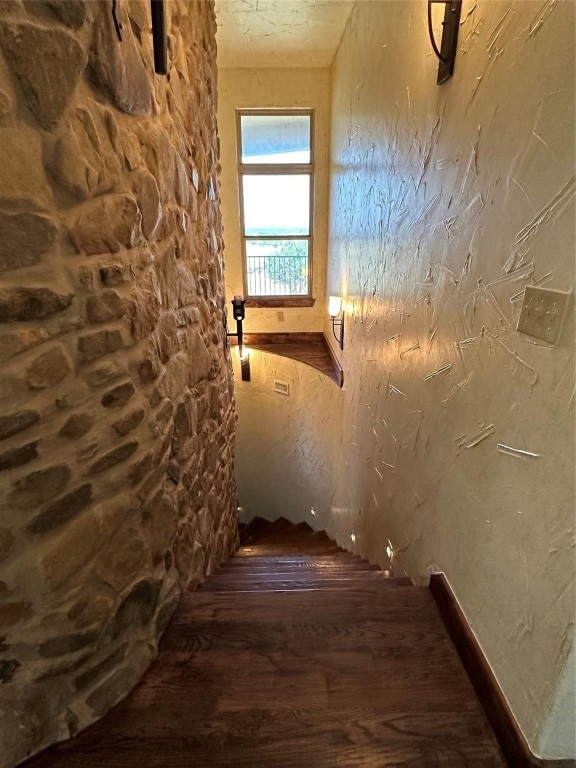 staircase with dark wood-type flooring