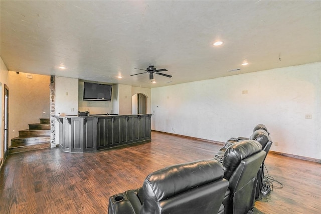 living room with dark hardwood / wood-style floors and ceiling fan