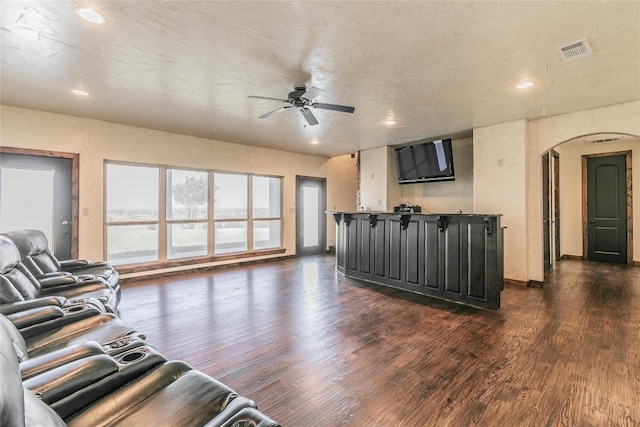 living room with ceiling fan and dark hardwood / wood-style flooring