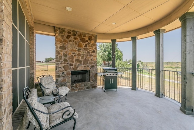 view of patio with an outdoor stone fireplace