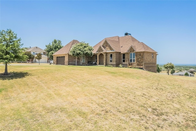 view of front of property featuring a front lawn and a garage