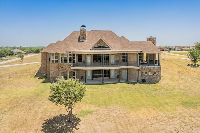 back of property with a patio area and a lawn