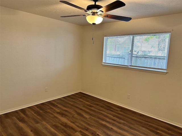 unfurnished room featuring ceiling fan and dark hardwood / wood-style flooring