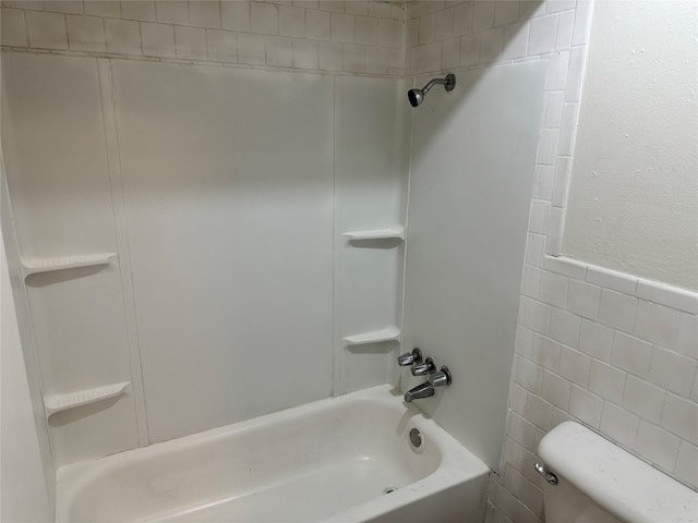 bathroom featuring shower / bathing tub combination and toilet