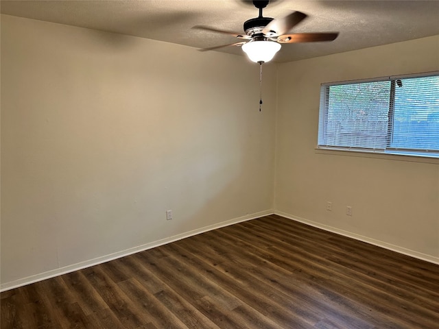 unfurnished room featuring dark hardwood / wood-style flooring, ceiling fan, and a textured ceiling