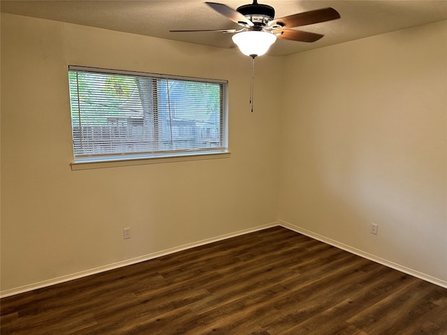 unfurnished room featuring ceiling fan and dark hardwood / wood-style flooring