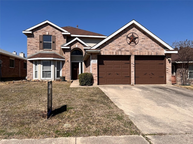 traditional-style house featuring an attached garage, a front lawn, concrete driveway, and brick siding