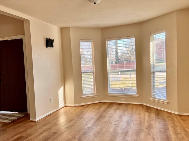 empty room featuring light wood-style floors and baseboards