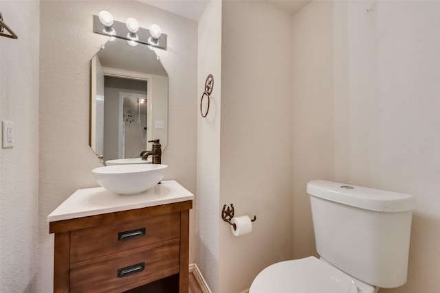 half bath with vanity and toilet