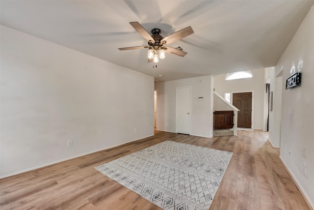 spare room with light wood finished floors and ceiling fan