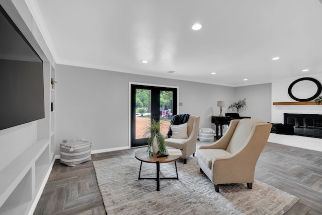 living room featuring parquet floors, a fireplace, and ornamental molding