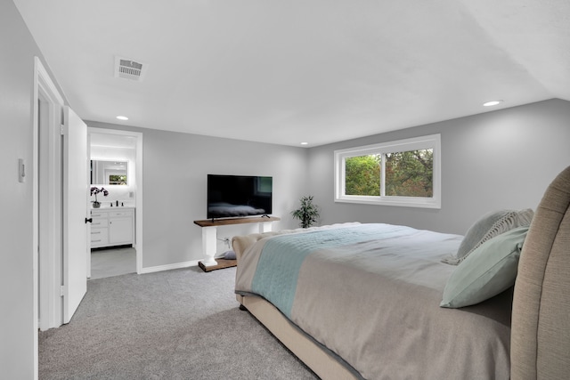 carpeted bedroom featuring ensuite bathroom