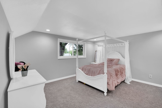 bedroom featuring vaulted ceiling and carpet