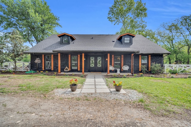 view of front of home with covered porch and a front yard