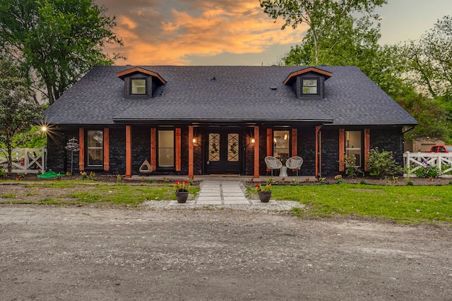 view of front of home with a lawn and a porch