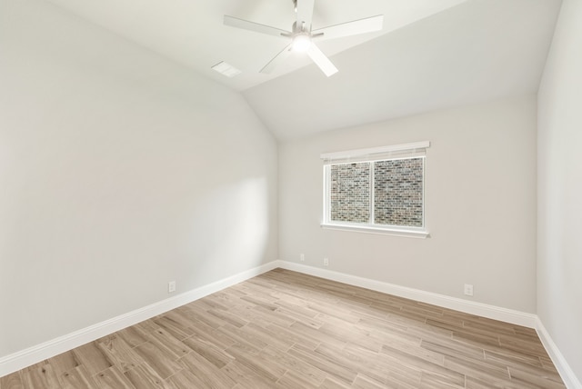 spare room with lofted ceiling, ceiling fan, and light hardwood / wood-style flooring