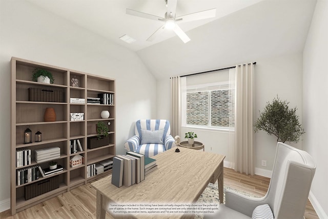 home office with light hardwood / wood-style flooring, ceiling fan, and vaulted ceiling