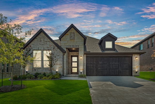 view of front facade with a lawn and a garage