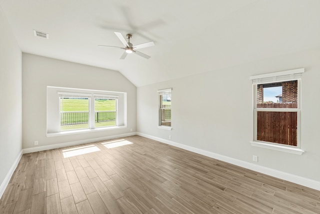 spare room featuring ceiling fan, vaulted ceiling, and light hardwood / wood-style floors