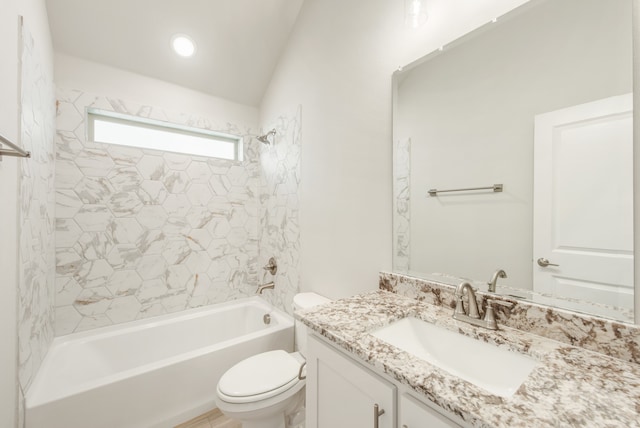 full bathroom featuring tiled shower / bath combo, vanity, and toilet