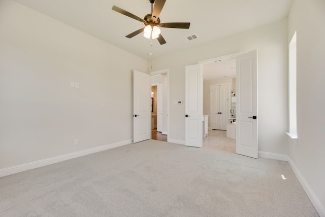 unfurnished bedroom featuring ceiling fan and light colored carpet