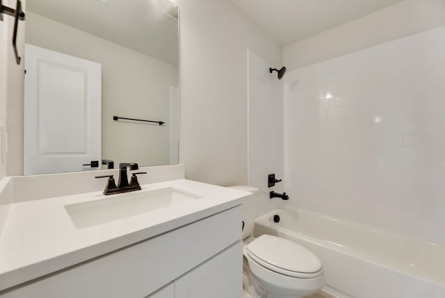 bathroom with toilet, vanity, and  shower combination