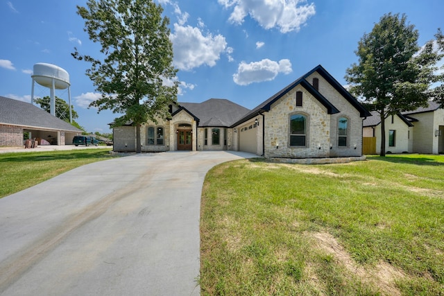 french provincial home with a front yard and a garage