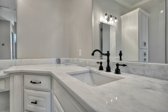 bathroom featuring vanity and ornamental molding