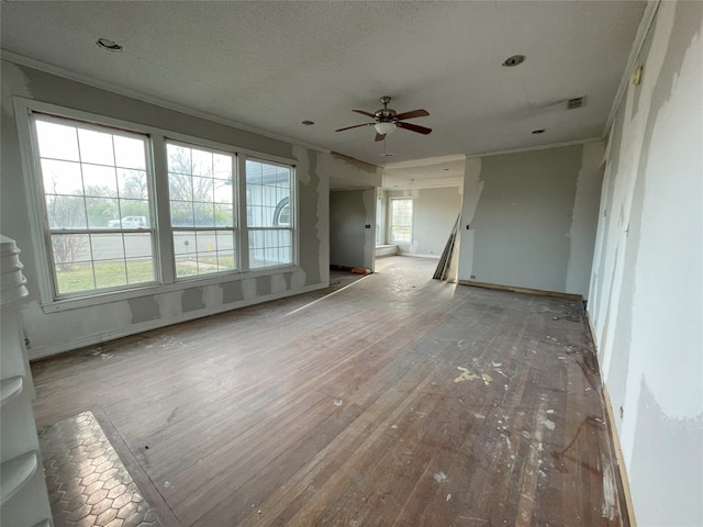 spare room with ceiling fan, a healthy amount of sunlight, light wood-type flooring, and crown molding