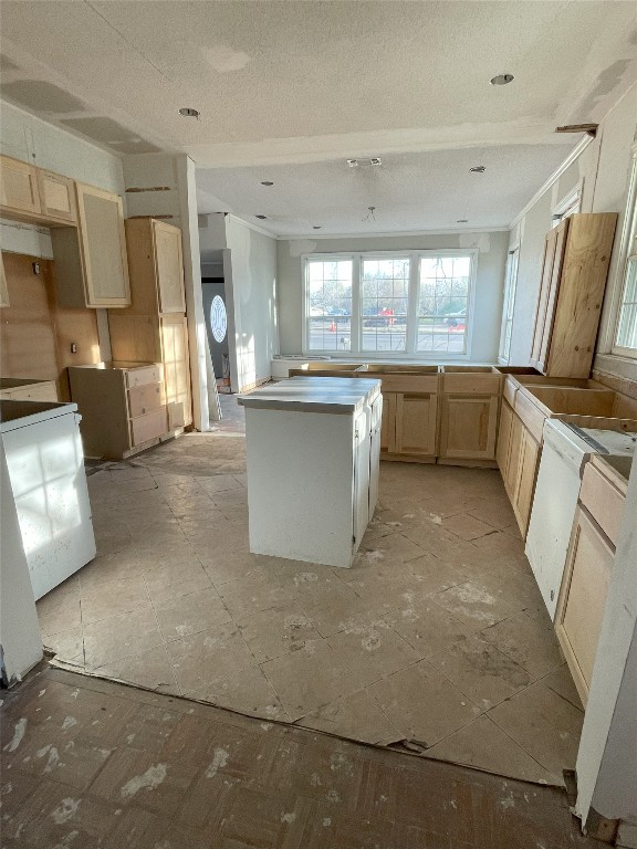 kitchen with a kitchen island and light brown cabinets