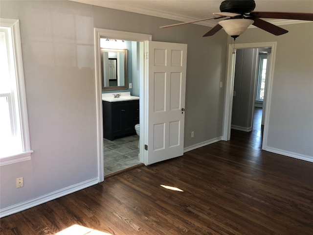 spare room with sink, ceiling fan, plenty of natural light, and dark wood-type flooring