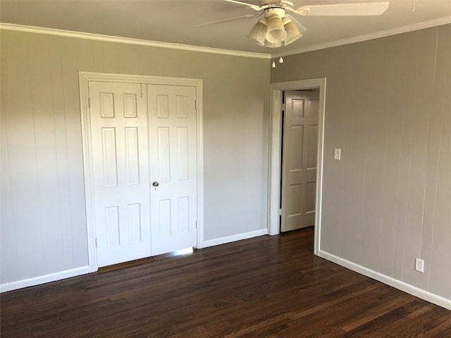 unfurnished bedroom featuring ornamental molding, a closet, dark hardwood / wood-style flooring, and ceiling fan