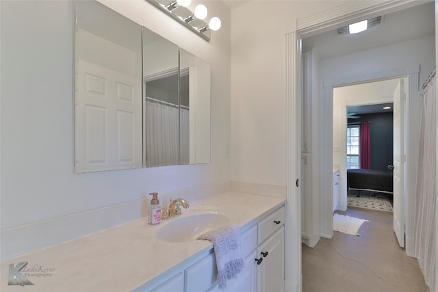 bathroom with vanity with extensive cabinet space and concrete floors