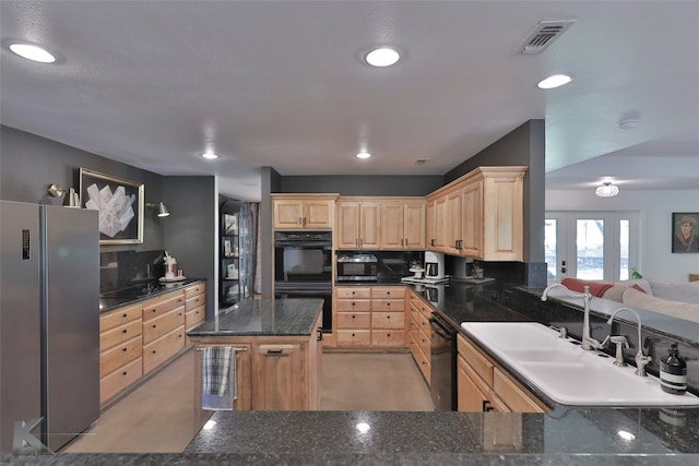 kitchen featuring black appliances, light brown cabinetry, backsplash, kitchen peninsula, and sink