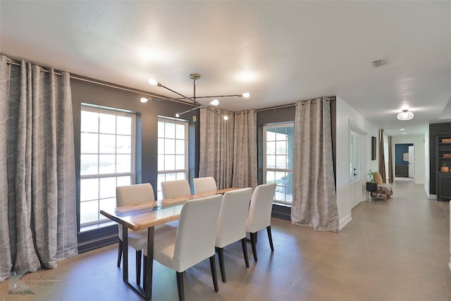 dining room featuring a chandelier and plenty of natural light