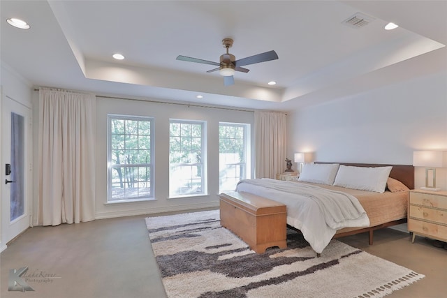 bedroom featuring ceiling fan and a tray ceiling