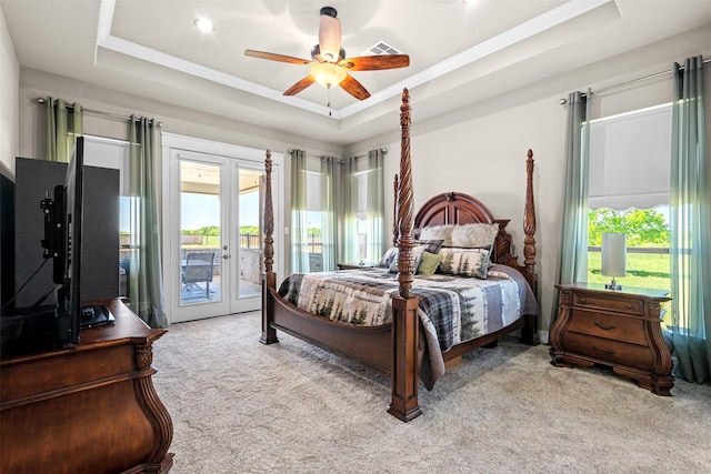 bedroom with light carpet, a tray ceiling, access to outside, and ceiling fan