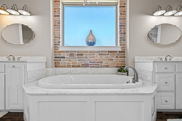 bathroom with a washtub, vanity, and a wealth of natural light