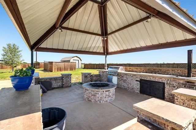 view of patio / terrace with area for grilling, a gazebo, and a fire pit