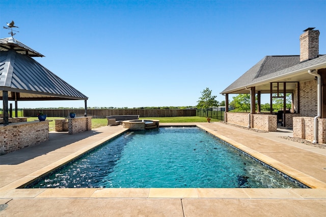 view of pool with a bar, a gazebo, a patio, and an in ground hot tub