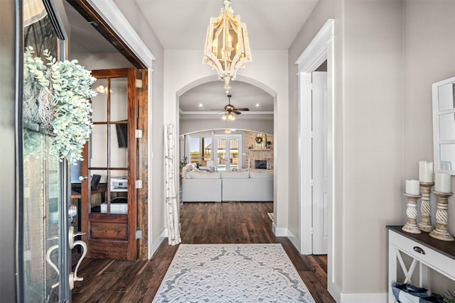 foyer featuring dark hardwood / wood-style floors and ceiling fan with notable chandelier