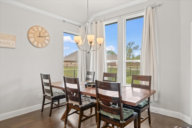 dining space with a healthy amount of sunlight, dark wood-type flooring, crown molding, and an inviting chandelier