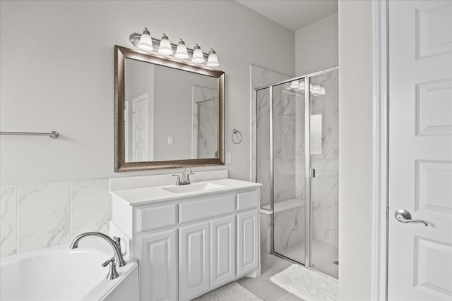 bathroom featuring vanity with extensive cabinet space, separate shower and tub, and tile floors