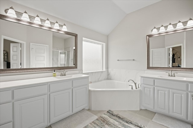 bathroom featuring vaulted ceiling, vanity, tile floors, and plus walk in shower