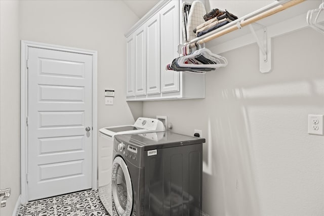 clothes washing area featuring washer and clothes dryer, hookup for an electric dryer, cabinets, and light tile floors