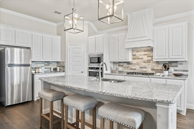 kitchen with white cabinets, dark hardwood / wood-style flooring, backsplash, and stainless steel appliances