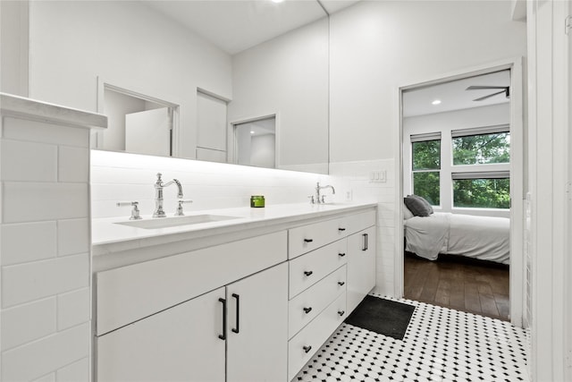 bathroom with decorative backsplash, vanity, and hardwood / wood-style flooring